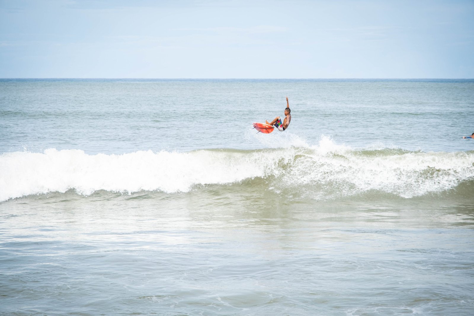 surfer doing Ariel in Sayulita Mexico by Susan Paige photography