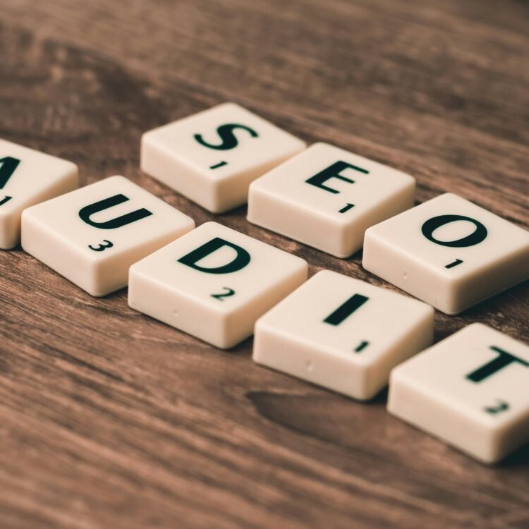 SEO AUDIT written in scrabble letters on wooden table