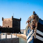 dynamic photo of Fishing boat and UNESCO world site in port of Essaouira Morocco