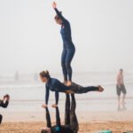 surf school students making a yoga pyramid on the beach in Essaouira Morocco for Loving Surf Essaouira