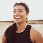 Smiling fitness instructor with hazy early sunrise for lifestyle photography