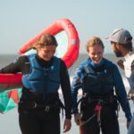 Smiling kitesurfers after their kite lessons on the beach for Surf school client Loving Surf in Essaouira Morocco