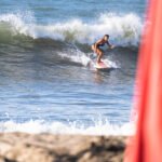 Woman surfing in Sayulita Mexico on a surf trip